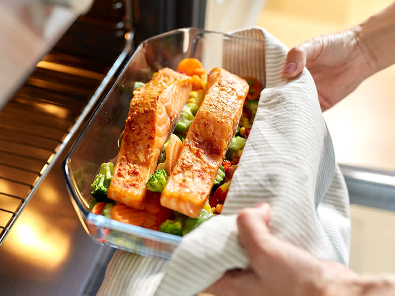 Salmon dish being put into the oven.
